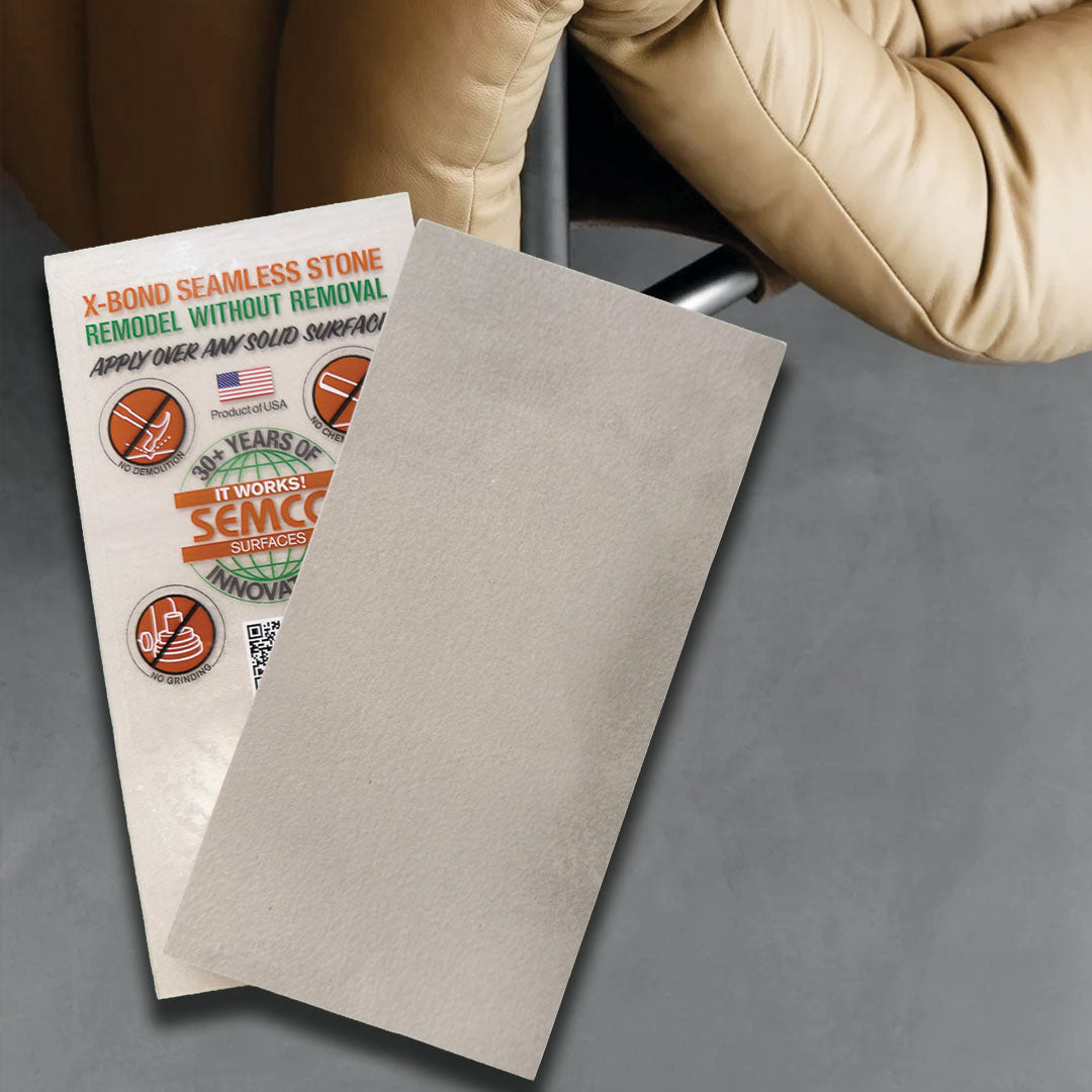Sheet of gray microcement with a promotional leaflet on a gray surface